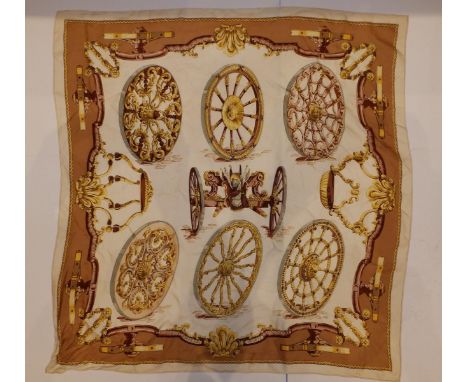 A silk Hermes headscarf - Gun carriage with wheel devices in brown and gold on cream ground, designed by Caty, 34.5" x 34".