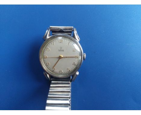 A 1940's gent;s stainless steel Tudor wrist watch, the white dial with gold Arabic numerals, cantre seconds, case diameter 30