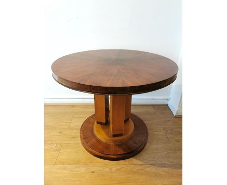An Art Deco kingwood and satinwood centre table raised on a pedestal base. H.66 dia. 64cm