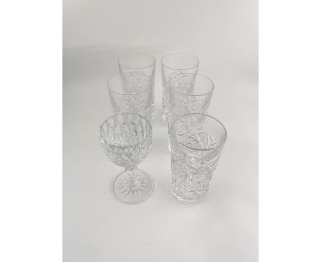 Four Baccarat crystal tall boys, a shorter version and a sherry glass. H.14cm tallest