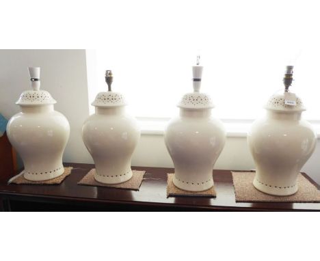 A set of four baluster-shaped cream ceramic table lamps (34cm high not including electrical fitting)