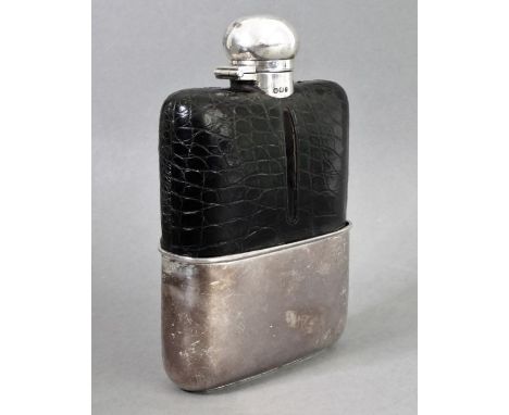 A fine and large hallmarked silver and leather-mounted glass spirit flask; the spherical silver top twisting to reveal cork s