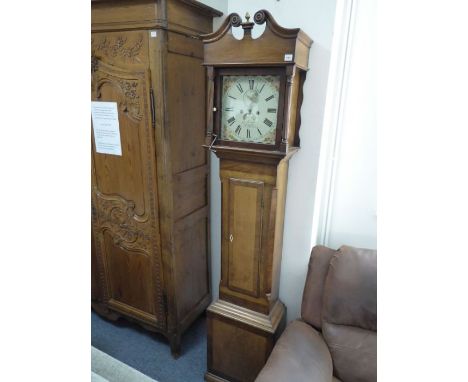 An early 19th century oak and mahogany crossbanded eight-day longcase clock; the broken swan-neck pediment with a brass finia