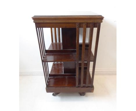 An early 20th century revolving oak bookcase on stand with castors (46cm square x 83cm high)Condition Report: The piece appea