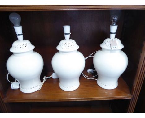 A set of three&nbsp;baluster-shaped cream ceramic table lamps (34cm high excluding electrical fitting)