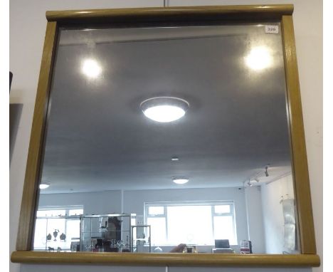A modern light oak-framed wall-hanging looking glass (frame size 63cm square)