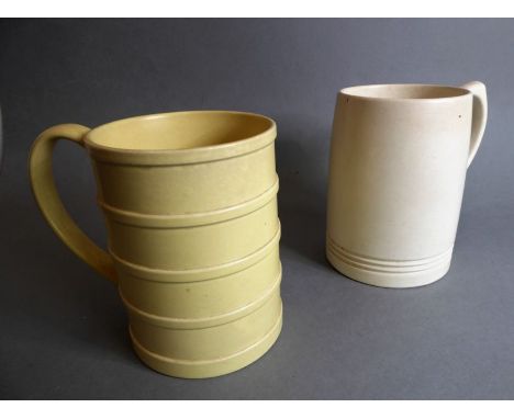 KEITH MURRAY for Wedgwood; two early 20th century tankards, both with printed marks to their undersides (the light-yellow rib
