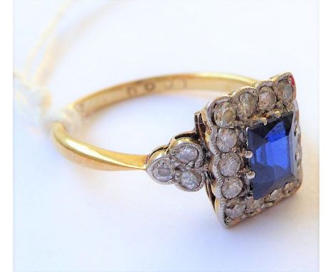 A sapphire and diamond-set ring, the rectangular-cut sapphire within a border of brilliant-cut diamonds and a diamond-set tre