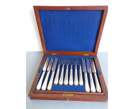 A late 19th century twelve-place silver-plated tea knife and fork set; each handle engraved with armorial, mahogany case 