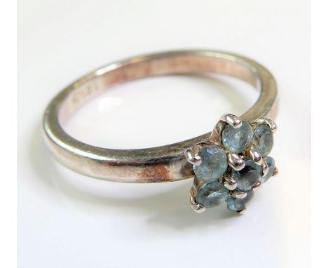 A lady's silver dress ring set with hand-cut light blue stones in a flowerhead cluster design (ring size L) (boxed)