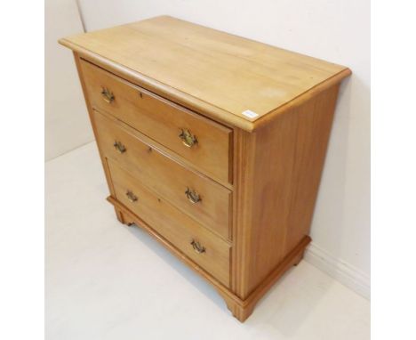 An early 20th century pine chest; the slightly overhanging thumbnail moulded top above three full-width graduated drawers wit