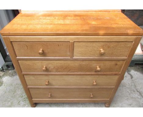 Robert Mouseman Thompson - oak chest of drawers with raised back and two short above three long drawers with turned wooden ha