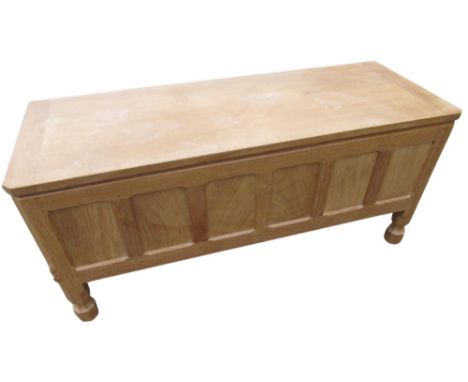 Robert Mouseman Thompson - panelled oak rectangular blanket box with hinged top on short octagonal baluster supports, carved 