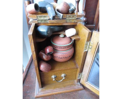 Edwardian oak smokers cabinet, fitted interior with pottery tobacco jar and cover above a single drawer, enclosed by bevelled