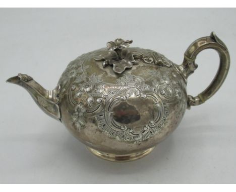 Victorian hallmarked silver bullet shaped teapot, decorated with scrolls, foliage and cartouche, floral cast finial and ivory