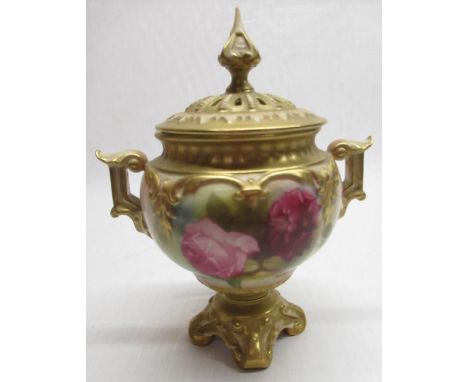 Royal Worcester pedestal vase, globular body painted with roses, gilt relief detail and handles, pierced cover with spire fin