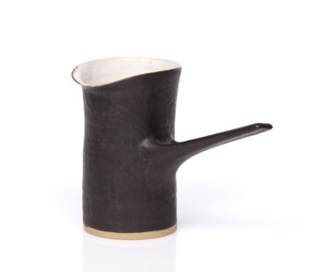 Lucie Rie (1902-1995) Pouring vessel manganese glaze impressed potter's seal 12.6cm high, 16.5cm across. 
