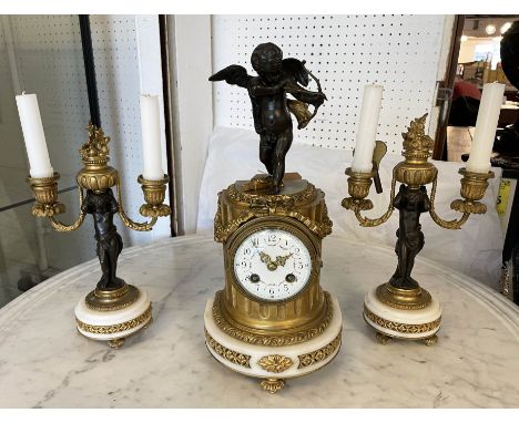 CLOCK GARNITURE, French 19th century, having cupid mounted on top of the clock, with matching candelabra, 38cm H. (3) 