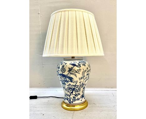 TABLE LAMP, 55cm high, 35cm diameter, blue and white glazed ceramic, gilt base, with a pleated shade. 