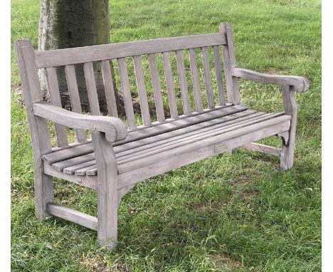 LISTER GARDEN BENCH, well weathered teak of Country House proportions, slatted with scroll arms, R A Liser and Co Ltd', genui