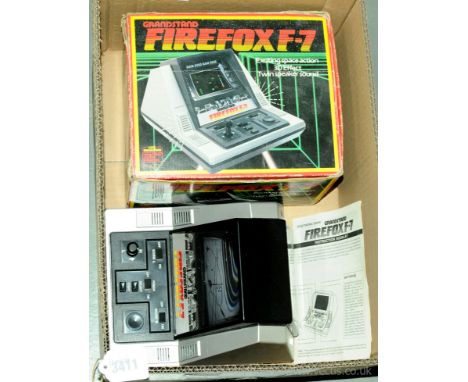 An early vintage boxed Gaming Console "Grandstand Firefox F-7" (Code No.11279) which generally appears to be Good but has not