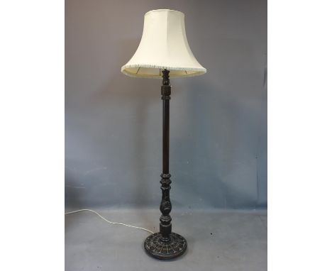 A carved mahogany standard lamp, raised on carved circular base, with shade, H.43cm 