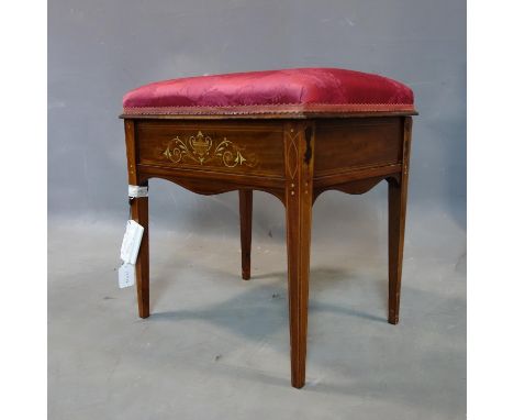 An Edwardian inlaid mahogany piano stool with hinged seat having marquetry inlay depicting urn and scrolling foliage, on boxw