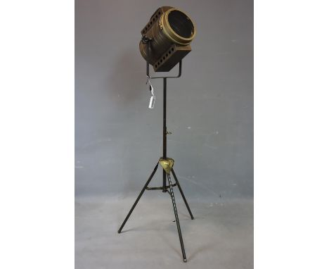 A contemporary adjustable theatre lamp, battery operated, on tripod stand, H.135cm 