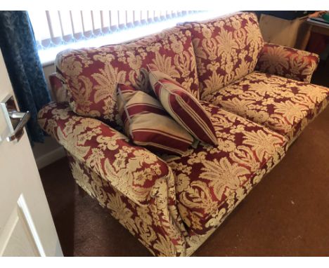 RED PATTERNED SOFA , 2 ARMCHAIRS &amp; FOOTSTOOL ALL ON BRASS CASTORS