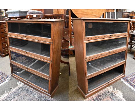 A Pair of 1930s Oak Four Tier Sectional Bookcases, 94cm by 29cm by 116cmOne bookcase with a missing glass panel on the bottom