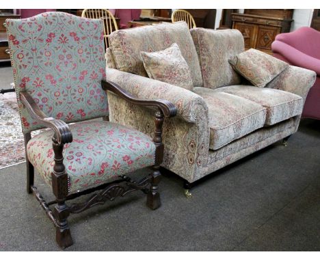 A Parker Knoll Two Seater Sofa, upholstered in an Art Nouveau style fabric, with turned feet and brass castors, 170cm wide; t