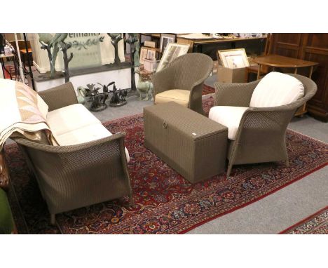 A Lloyd Loom Four Piece Grey Painted Wicker Conservetory Suite, comprising a sofa, two chairs and a coffee table with a hinge