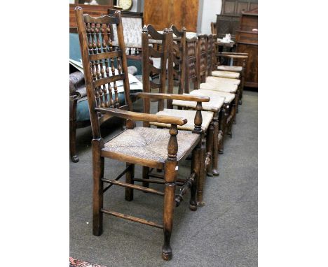 A Mixed Set of Eight Rush Seated Hardwood Dining Chairs, with an assortment of spindle and ladder backs (including 2 carver c