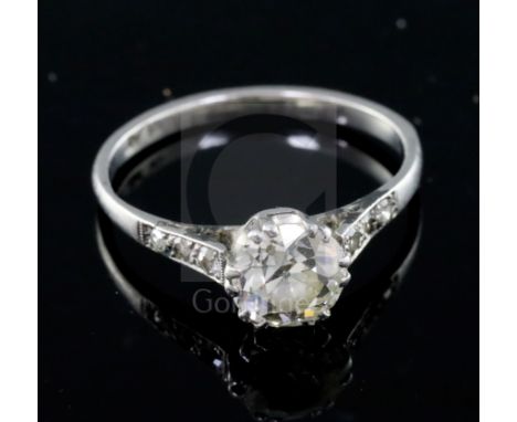 A mid 20th century platinum and single stone diamond ring, with diamond set shoulders, the central stone weighing approximate