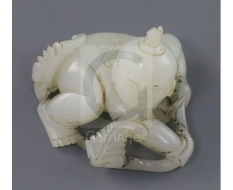 A Chinese white jade figure of a boy, 19th century, crouching and holding a leafy tendril, the stone of good even tone, 5.5cm