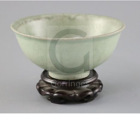 A Chinese Longquan celadon bowl, Ming dynasty, with burnt orange ring to the base, D. 18.5cm, crackle to glaze, wood stand