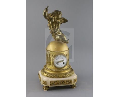 A late 19th century French ormolu mantel clock, surmounted with a figure of Cupid holding grapes, with floral painted enamell