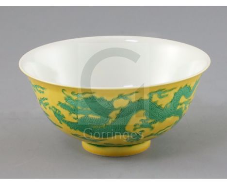 A Chinese yellow ground 'dragon' bowl, probably Qianlong mark and period, with incised green dragons chasing a flaming pearl,