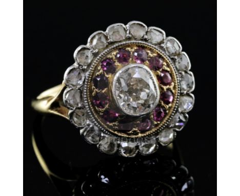 An 18ct gold, ruby and diamond target cluster ring, the central diamond measuring approximately 5.1mm by 4.4mm, with a depth 
