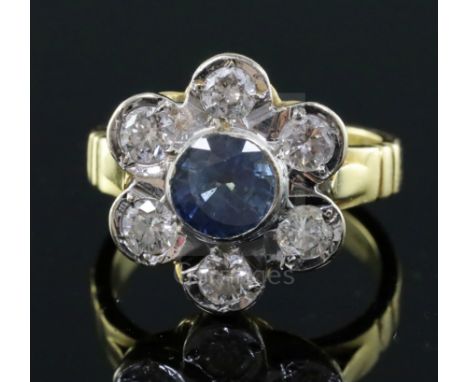 A modern 18ct gold, sapphire and diamond seven stone flowerhead cluster ring, size J/K.