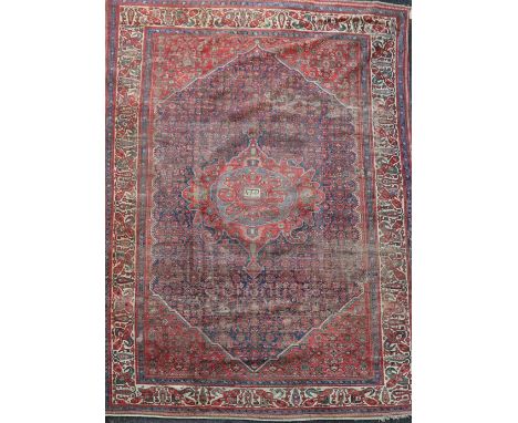 An antique Malayer carpet, dated 1905, with central medallion in a field of geometric motifs and multi row border (a.f.), 14f