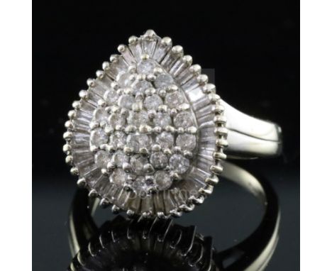 A modern 18ct white gold and diamond pear shaped cluster dress ring, set with round and baguette cut diamonds with a total ca