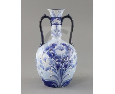 A Moorcroft Florian ware two handled vase, c.1900, decorated with blue and white flowers, brown printed Florian ware mark, gr