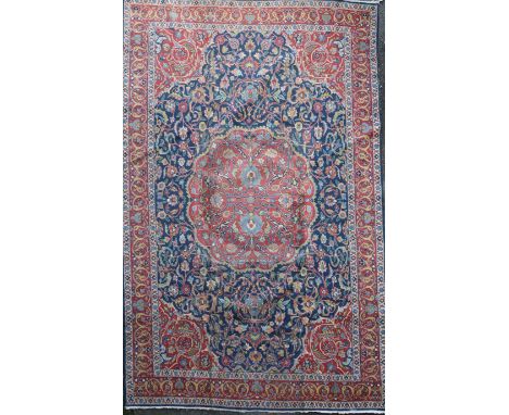 A Tabriz carpet, with central medallion in a field of scrolling foliage, with three row border, 12ft 7in by 9ft 4in.