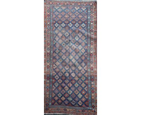 An antique Bidjar carpet, with field of foliate motifs, on a blue ground, 11ft 4in by 5ft 4in