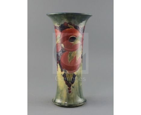 An early Moorcroft 'pomegranate' trumpet shaped vase, c.1917, with a buff / pale blue mottled ground, impressed mark Moorcrof