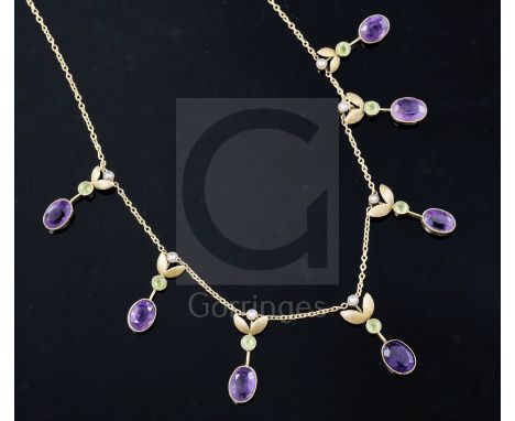 An Edwardian 15ct gold, amethyst, peridot and seed pearl set drop necklace, 40cm.