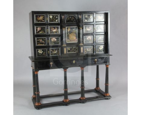 A 17th/18th century Italian and later pietra dura and ebony veneered cabinet on an ebonised wood stand, the cabinet with an a