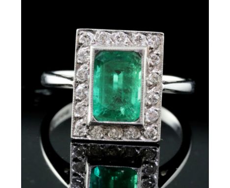 An Art Deco style 18ct white gold, emerald and diamond tablet cluster ring, size O.