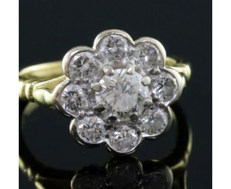 A modern 18ct gold and nine stone diamond flowerhead cluster ring, size J.